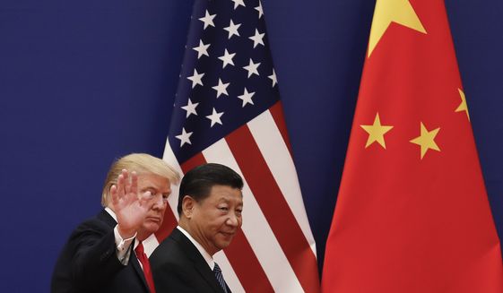 U.S. President Donald Trump waves next to Chinese President Xi Jinping after attending a business event at the Great Hall of the People in Beijing, Thursday, Nov. 9, 2017. Trump is on a five-country trip through Asia traveling to Japan, South Korea, China, Vietnam and the Philippines. (AP Photo/Andy Wong) **FILE**