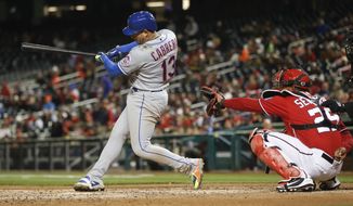 New York Mets Asdrubal Cabrera (13) connects for a homer off Washington Nationals starting pitcher Tanner Roark during the fifth inning of baseball game at Nationals Park, Sunday, April 8, 2018, in Washington. Behind the plate is Washington Nationals catcher Pedro Severino (29). (AP Photo/Pablo Martinez Monsivais)