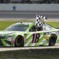 Kyle Busch (18) celebrates his win in a NASCAR Cup series auto race in Fort Worth, Texas, Sunday, April 8, 2018. (AP Photo/Randy Holt)
