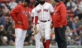 Boston Red Sox&#39;s Xander Bogaerts, center, is assisted as he leaves the field as manager Alex Cora, left, looks on in the seventh inning of a baseball game against the Tampa Bay Rays, Sunday, April 8, 2018, in Boston. (AP Photo/Steven Senne)