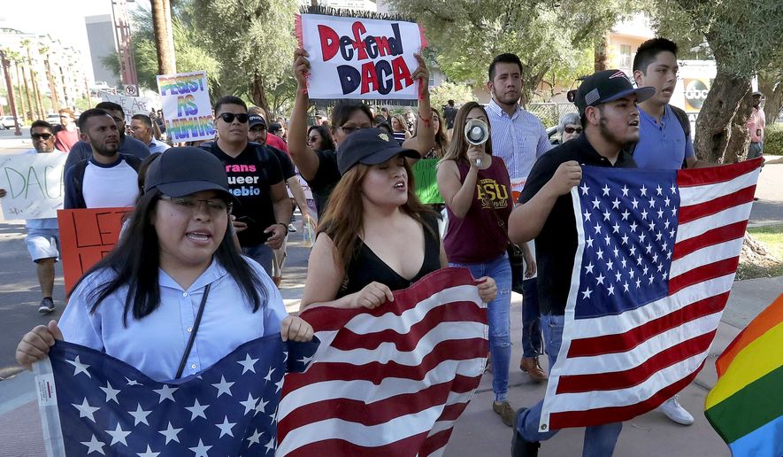 Deferred Action for Childhood Arrivals (DACA) supporters march to the Immigration and Customs Enforcement office to protest shortly after U.S. Attorney General Jeff Sessions&#39; announcement that the Deferred Action for Childhood Arrivals (DACA), will be suspended with a six-month delay, Tuesday, Sept. 5, 2017, in Phoenix. (AP Photo/Matt York) ** FILE **