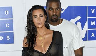Kim Kardashian West and Kanye West arrive at the MTV Video Music Awards in New York, Aug. 28, 2016. The couple married in 2014 and have three children. (Photo by Evan Agostini/Invision/AP) ** FILE **