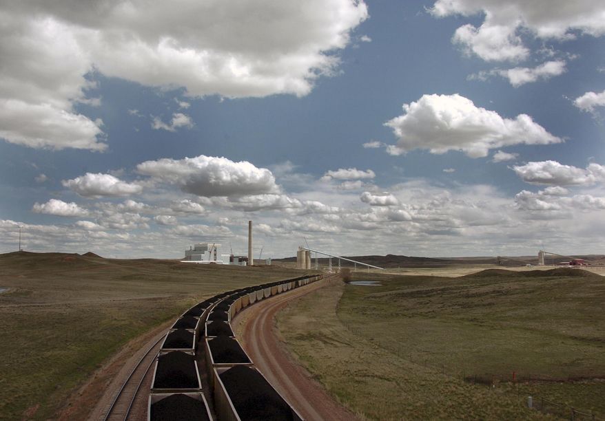FILE - In this April 29, 2010 file photo, a pair of coal trains idle on the tracks near Dry Fork Station, a coal-fired power plant being built by the Basin Electric Power Cooperative near Gillette, Wyo. Ten teams competing to make money from carbon dioxide pollution will share $5 million in prize money and advance to the final round of an international competition. Five of the finalists will compete to make use of actual flue gases from this Wyoming plant. The other five will compete at a gas-fired power plant in Alberta, Canada. (AP Photo/Matthew Brown, File)