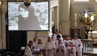In this May 16, 2012, file photo, a choir performs a hymn during the memorial service for Marie Colvin, the Sunday Times war correspondent who was killed in Homs, Syria on Feb. 22, at St Martin-in-the-Fields church in central London. Syria President Bashar Assad’s forces targeted Colvin and then celebrated after they learned their rockets had killed her, according to a sworn statement a former Syrian intelligence officer made in a wrongful death suit filed by her relatives. (AP Photo/Lefteris Pitarakis, File)