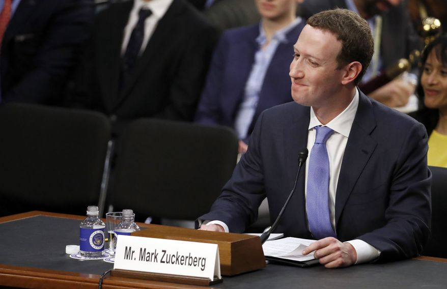Facebook CEO Mark Zuckerberg reacts to a question about the hotel he stayed in last night as he testifies before a joint hearing of the Commerce and Judiciary Committees on Capitol Hill in Washington, Tuesday, April 10, 2018, about the use of Facebook data to target American voters in the 2016 election. (AP Photo/Alex Brandon)