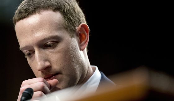 Facebook CEO Mark Zuckerberg pauses while testifying before a joint hearing of the Commerce and Judiciary Committees on Capitol Hill in Washington, Tuesday, April 10, 2018, about the use of Facebook data to target American voters in the 2016 election. (AP Photo/Andrew Harnik)