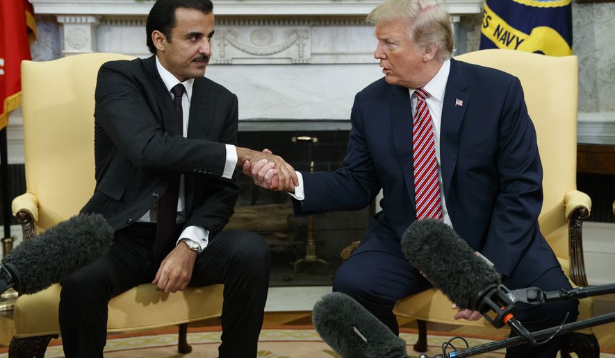 President Donald Trump shakes hands with Emir of Qatar Sheikh Tamim bin Hamad al-Thani in the Oval Office of the White House, Tuesday, April 10, 2018, in Washington. (AP Photo/Evan Vucci)