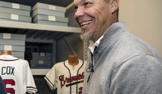 Hall of Fame inductee Chipper Jones laughs as he holds a candy bar named after him during his orientation tour of the Baseball Hall of Fame in Cooperstown, N.Y., Tuesday, April 10, 2018. The former Atlanta Braves slugger toured the Baseball Hall of Fame to prepare for his induction this summer, when he will be inducted along with Jim Thome, Vladimir Guerrero, Trevor Hoffman, Alan Trammell and Jack Morris on July 29. (Milo Stewart Jr./National Baseball Hall of Fame and Museum via AP)