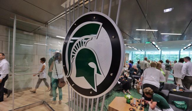 In this Aug. 25, 2014, file photo, people tour the new North End Zone Complex renovations at Spartan Stadium on the Michigan State Campus in East Lansing, Mich. (Ryan Garza/Detroit Free Press via AP, File) **FILE**