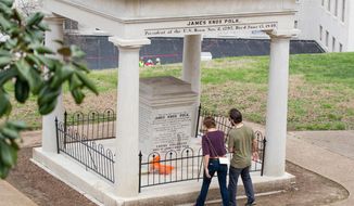 FILE - In a March 24, 2017 file photo, visitors look at the burial place of President James K. Polk and his wife, Sarah Polk, on the grounds of the state Capitol in Nashville, Tenn. The body of former president James K. Polk has been moved three times since he died of cholera in 1849, and now an effort to move it again has taken on a life of its own in the Tennessee Legislature. A much-debated resolution urging that his remains be moved to a fourth resting place appeared dead in March 2018, but was resurrected before winning final approval Monday night, April 9, 2018, in the House. (AP Photo/Erik Schelzig, File)
