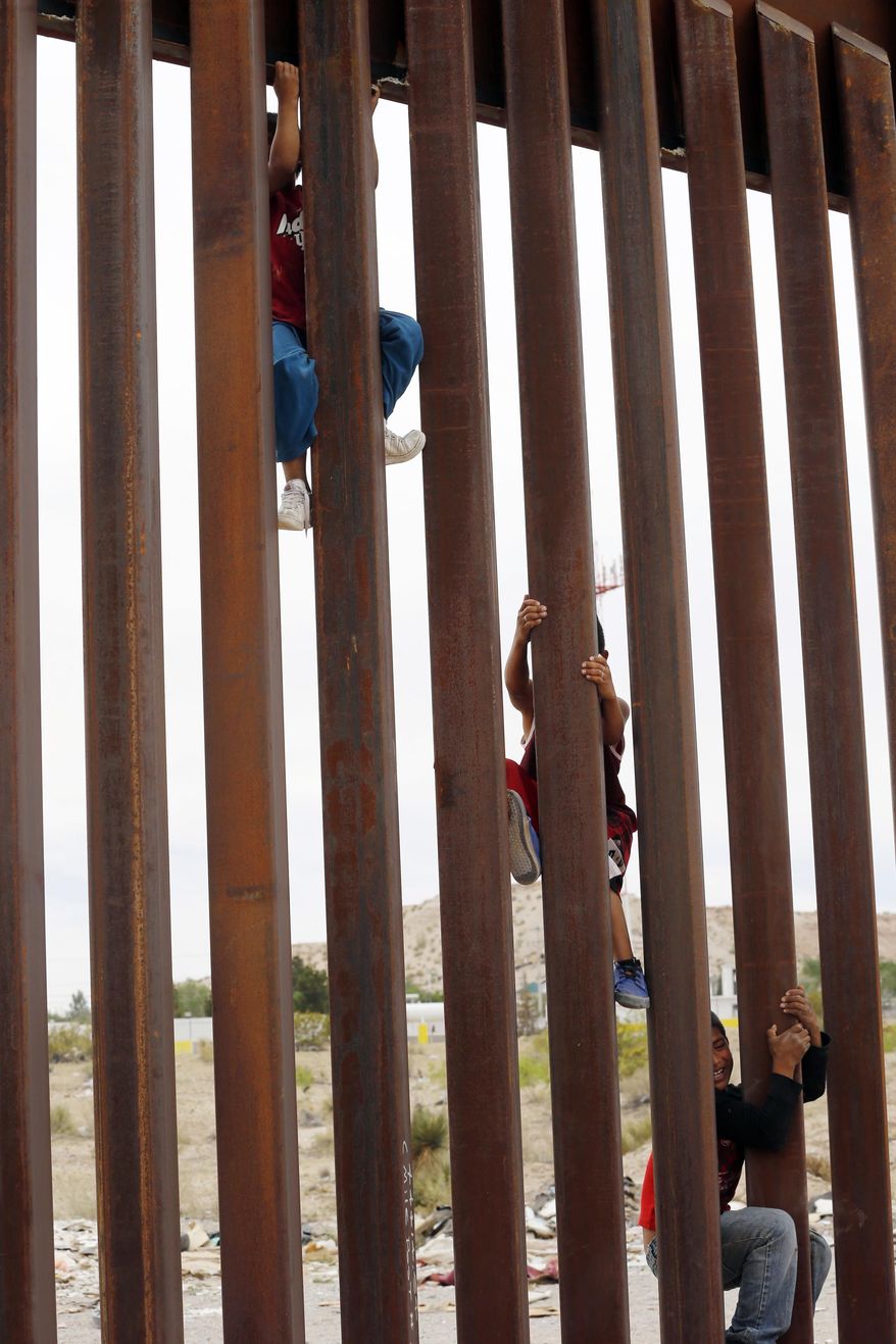 Children from Anapra, Mexico, climb a section of the new border wall recently built near Santa Teresa, N.M., Monday, April 9, 2018. The head of the U.S. Border Patrol sector that includes part of West Texas and all of New Mexico said Monday he met with leaders of the New Mexico National Guard to begin discussions about what will be required and their capabilities. (Ruben R. Ramirez/The El Paso Times via AP)