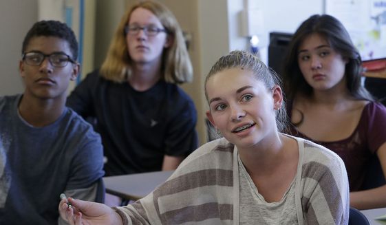 In this Oct. 8, 2015, photo, Audrey Crook, center, speaks during a ninth-grade Teen Talk High School class at Carlmont High School in Belmont, Calif. Sex education in some American high schools is evolving beyond pregnancy and disease prevention to include lessons aimed at curbing sexual assaults. (AP Photo/Jeff Chiu)