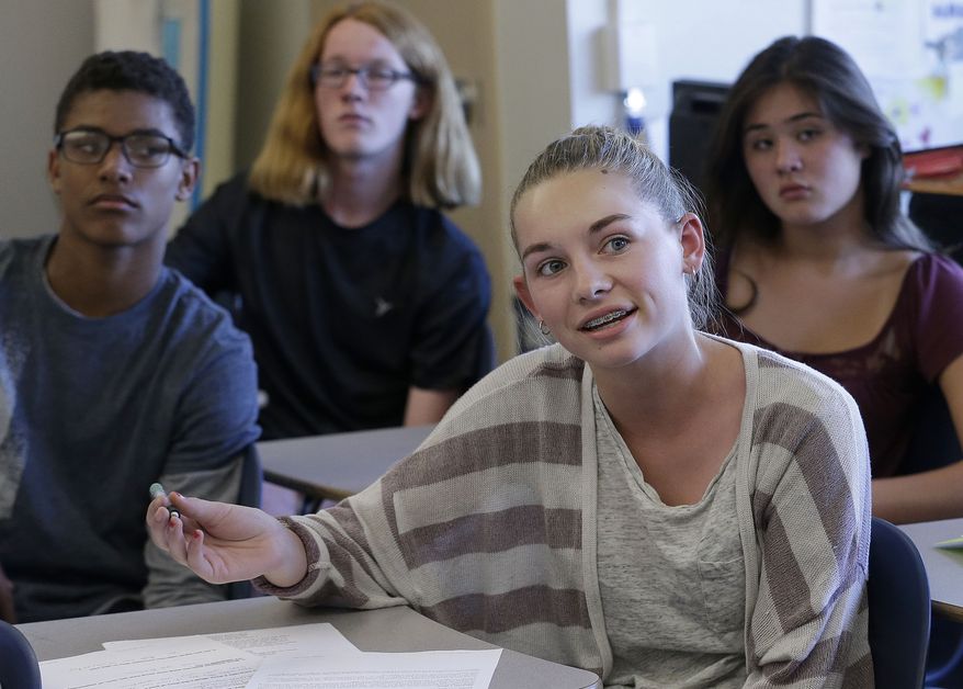 In this Oct. 8, 2015, photo, Audrey Crook, center, speaks during a ninth-grade Teen Talk High School class at Carlmont High School in Belmont, Calif. Sex education in some American high schools is evolving beyond pregnancy and disease prevention to include lessons aimed at curbing sexual assaults. (AP Photo/Jeff Chiu)