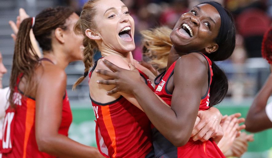England's Helen Housby, left, and Jodie Gibson celebrate after beating New Zealand during their preliminary round netball game at the Gold Coast Convention and Exhibition Centre during the 2018 Commonwealth Games on the Gold Coast, Australia, Wednesday, April 11, 2018. (AP Photo/Mark Schiefelbein)