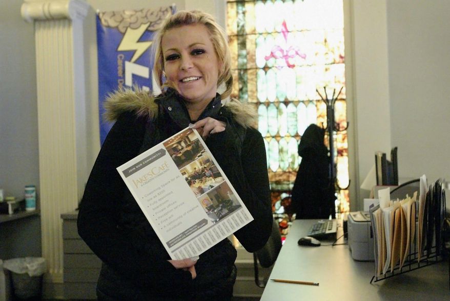 In this April 5, 2018, photo, Holly Pospichal holds a marketing piece as she did for Jake's Cafe, which currently houses over 30 businesses in Sheboygan, Wis. Pospichal is a business intern with Lakeshore Technical College in Cleveland, Wis. (Marina Affo/The Post-Crescent via AP)