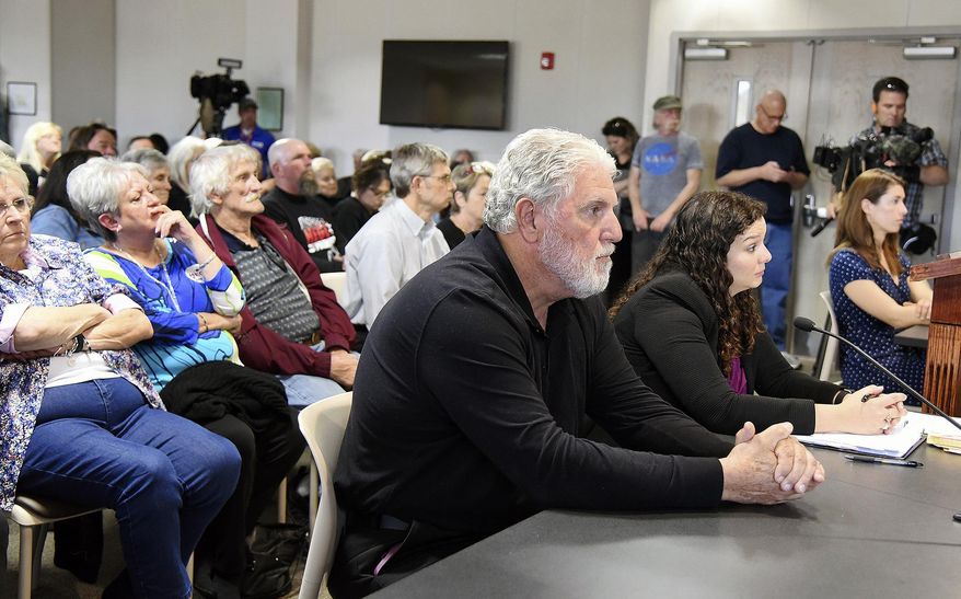 In this Tuesday, April 10, 2018 photo, from left, Gerald Hege and his lawyer, Katie Hall, sit at an election challenge hearing by Davidson County Board of Elections, in Lexington, N.C. At far right is challenger Angela Anderson. The Davidson County Board of Elections held the hearing on a challenge to sheriff candidate Hege's bid for office. They voted 3-1 Tuesday to grant Hege, a former North Carolina sheriff famous for painting his jail cells pink and hosting a cable television show before he pleaded guilty to felony charges, permission to run for his old office. (Laura Greene/The High Point Enterprise via AP)