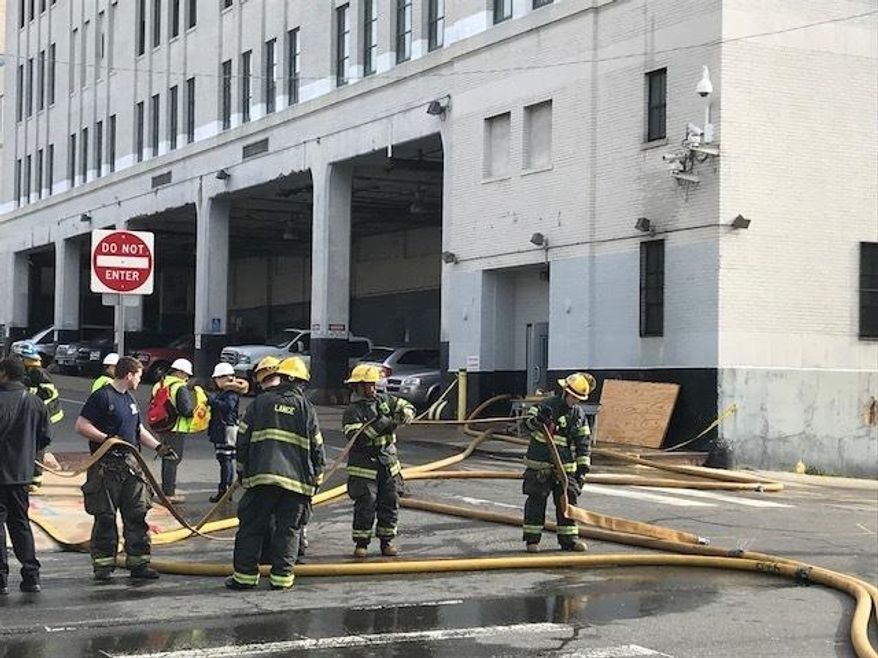 Philadelphia fire department works the scene of a fire at the former offices of the Philadelphia Inquirer and Daily News on Wednesday, April 11, 2018 in Philadelphia. Emergency crews blocked surrounding streets, causing traffic jams in the middle of the morning rush. There’s no word on what caused the blaze or where it started, but a spokesman says initial reports show the fire started inside the building. No injuries have been reported. ( Jessica Griffin /The Philadelphia Inquirer via AP)