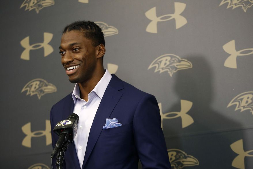 Newly-signed Baltimore Ravens backup quarterback Robert Griffin III speaks at an NFL football news conference at the team's headquarters in Owings Mills, Md., Wednesday, April 11, 2018. Griffin is returning to football after sitting out last season. (AP Photo/Patrick Semansky)