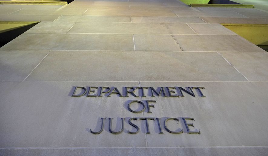 The Department of Justice headquarters building in Washington is photographed early in the morning on May 14, 2013. (Associated Press) ** FILE **