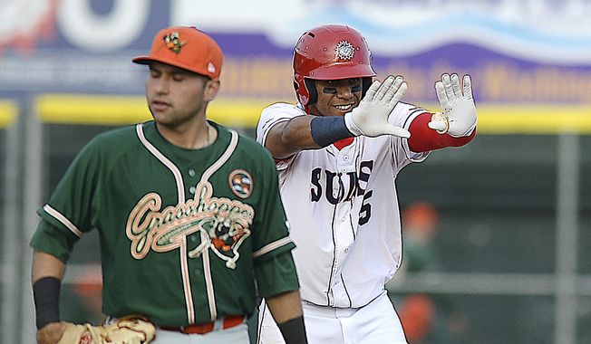 Hagerstown Suns&#x27; Juan Soto celebrates at second base as Greensboro Grasshoppers Eric Gutierrez walks past during a Class-A baseball game Thursday, April 12, 2018,  in Hagerstown, Md. (Colleen McGrath/The Herald-Mail via AP) **FILE**