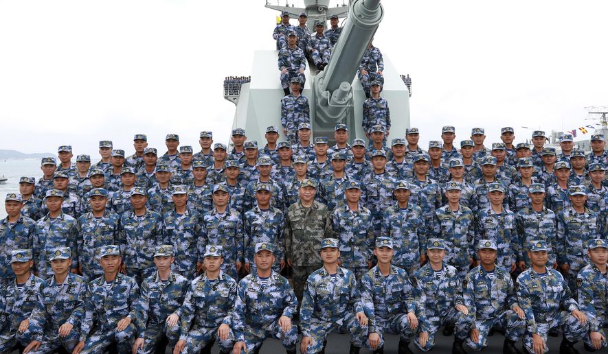 In this April 12, 2018 photo released by Xinhua News Agency, Chinese President Xi Jinping, center in green military uniform, poses with soldiers on a navy ship after he reviewed the Chinese People&#x27;s Liberation Army (PLA) Navy fleet in the South China Sea. China has announced live-fire military exercises in the Taiwan Strait amid heightened tensions over increased American support for Taiwan. The announcement by authorities in the coastal province of Fujian on Thursday was accompanied by a statement that the navy was ending a three-day exercise in the South China one day early. (Li Gang/Xinhua via AP)