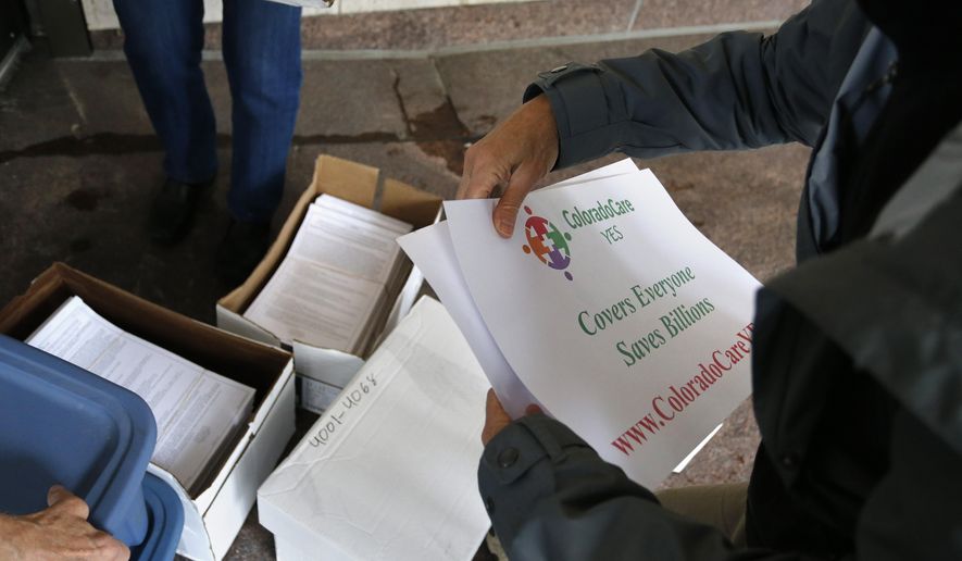 FILE - In this Oct. 23, 2015 file photo, volunteers help deliver petition signatures to put a health care question on the 2016 Colorado ballot. A federal appeals court has stopped a judge’s order blocking parts of Colorado's Amendment 71, which makes it more difficult for citizens to get any proposed constitutional amendments onto ballots, from taking effect. The ruling by the 10th U.S. Circuit Court of Appeals puts the amendment temporarily back in effect for petition signatures for any constitutional initiatives proposed for the November 2018 ballot, according to the Colorado Secretary of State's Office. (AP Photo/Brennan Linsley, File)