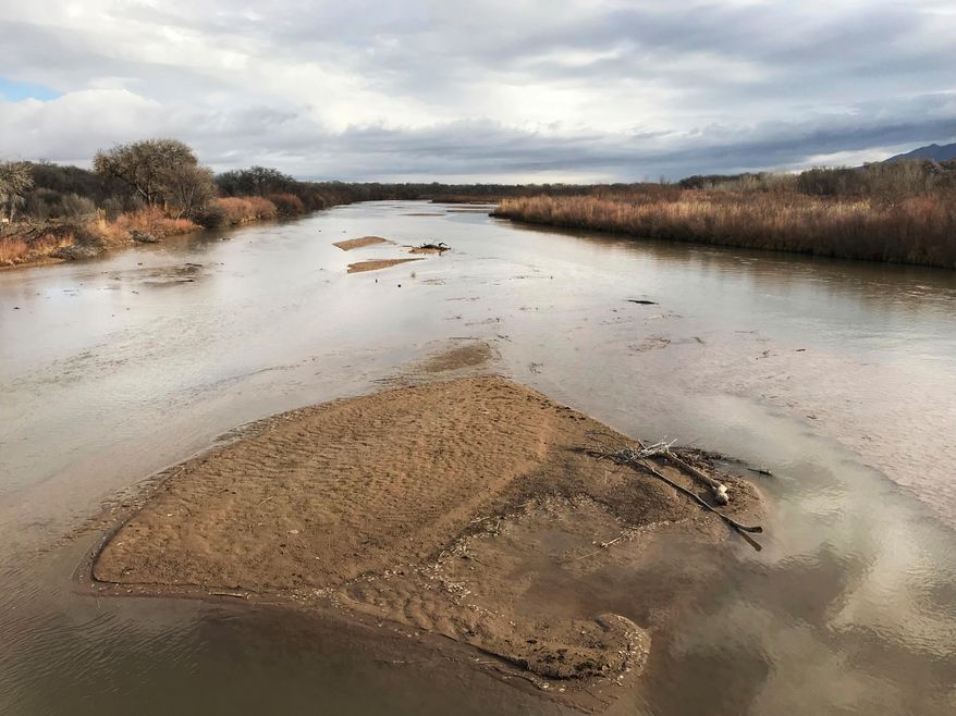 FILE - In this Feb. 22, 2018 file photo, sandbars fill the Rio Grande north of Albuquerque, N.M. Drought is stiffening its hold across the American Southwest as extreme conditions spread from Oklahoma to Utah. The federal drought map released Thursday, April 12, 2018, shows dry conditions especially intensified across northern New Mexico and expanded in Arizona. (AP Photo/Susan Montoya Bryan, File)