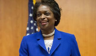 FILE - In this Feb. 26, 2015, FCC Commissioner Mignon Clyburn, takes her seat before the start of an FCC open hearing and vote on Net Neutrality in Washington, D.C. Clyburn addressed a gathering of librarians and other experts Thursday, April 12, 2018, in Washington, D.C., as the group discussed challenges to providing high-speed internet in American Indian communities. (AP Photo/Pablo Martinez Monsivais, file)