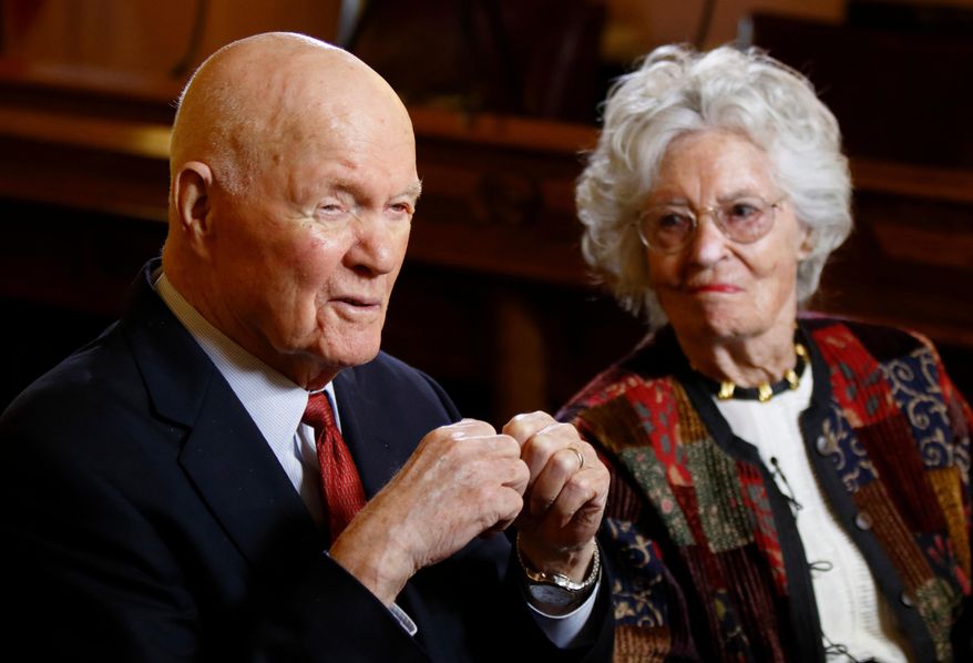 FILE – In this May 14, 2015, file photo, former astronaut and U.S. Sen. John Glenn, D-Ohio, left, answers questions with his wife Annie Glenn during an interview with The Associated Press at the Ohio Statehouse in Columbus, Ohio. The state House unanimously approved a resolution on Wednesday, April 11, 2018, urging Congress to recognize Glenn and his widow with a Congressional Gold Medal. (AP Photo/Paul Vernon, File)