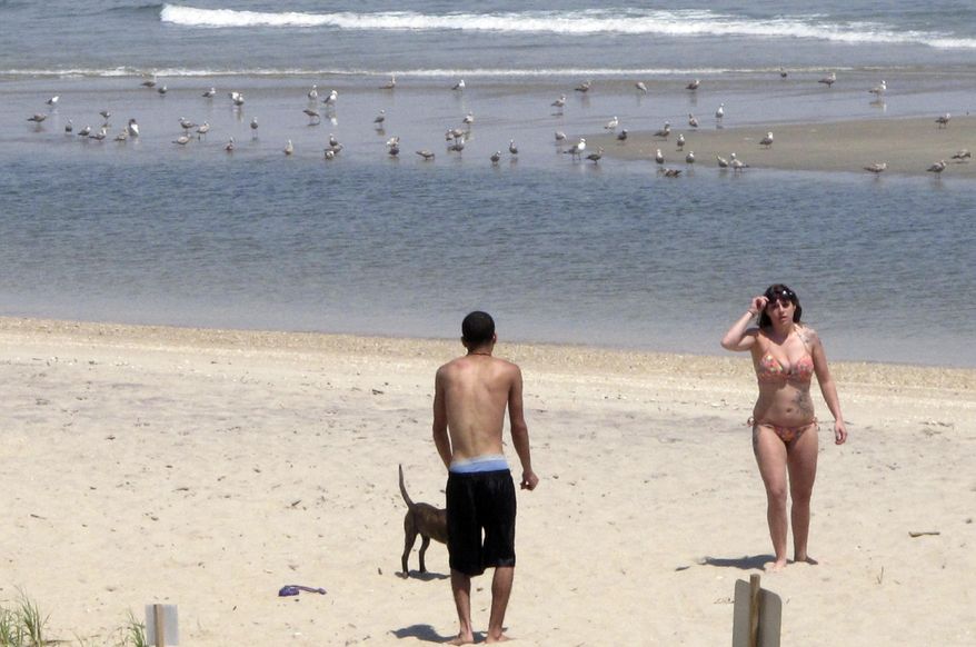 This May 15, 2015 photo shows beachgoers on the sand in Sea Bright, N.J. New Jersey is prepared to thwart President Trump's plan for offshore oil and gas drilling by enacting a ban on such activity or its supporting infrastructure in state waters. The state Assembly is poised to give final legislative approval Thursday, April 12, 2018, to a measure banning not only drilling in state waters, but any activity that supports it such as pipelines and docks. (AP Photo/Wayne Parry)