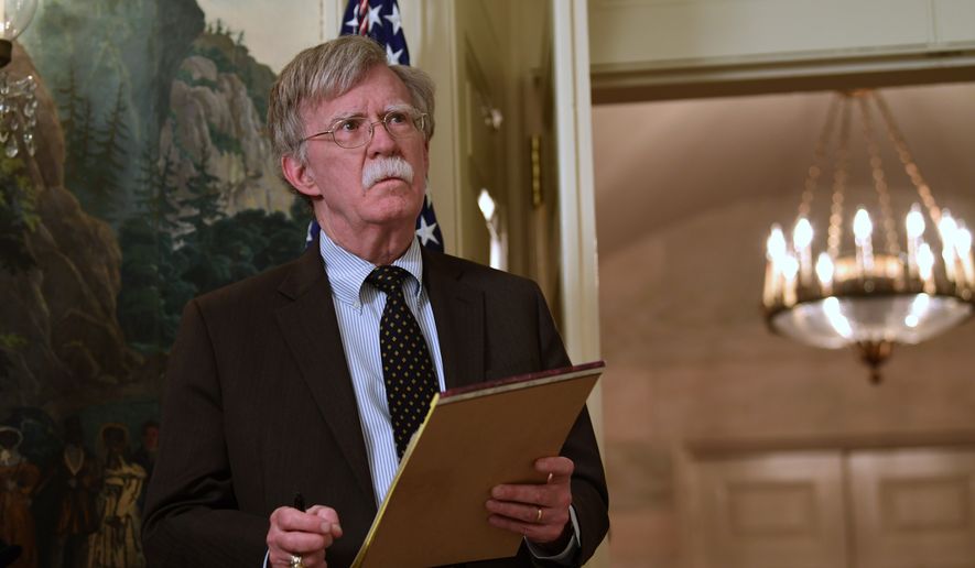 National security adviser John Bolton listens President Donald Trump speaks in the Diplomatic Reception Room of the White House on Friday, April 13, 2018, in Washington, about the United States&#x27; military response to Syria&#x27;s chemical weapon attack on April 7. (AP Photo/Susan Walsh)