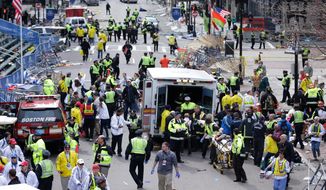 FILE - In this April 15, 2013 file photo, medical workers aid injured people following an explosion at the finish line of the 2013 Boston Marathon in Boston. Twin bombs near the finish line of one of the world&#39;s most storied races killed three people and injured 260 others, many of whom lost their legs, five years ago on April 15, 2013. (AP Photo/Charles Krupa, File)