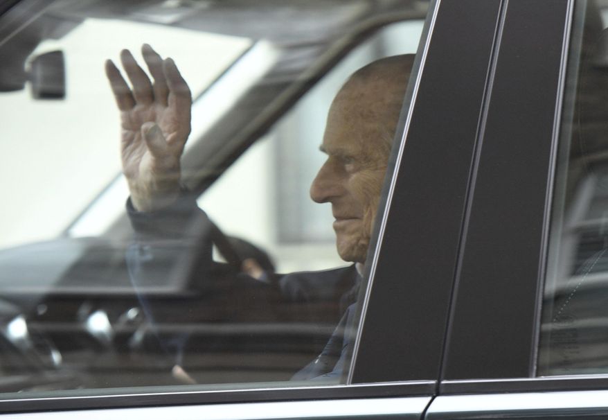 Britain's Prince Philip waves as he leaves the King Edward VII Hospital, after recovering from a planned surgery last Wednesday, in London, Friday, April 13, 2018. (Victoria Jones/PA via AP)