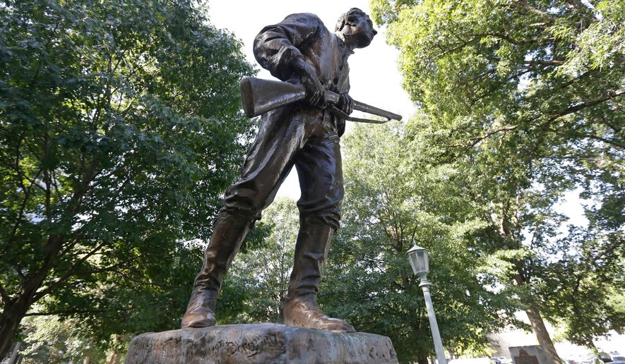 This Tuesday, Sept. 19, 2017, photo shows a Confederate monument honoring Henry Lawson Wyatt at the state Capitol in Raleigh, N.C. Three Confederate monuments on North Carolina's state Capitol grounds erected during the Jim Crow era of white supremacy should be moved or include historical context if the law doesn't allow their relocation, say historians consulted by a committee crafting a response to the governor's request to find a new home for the statues.(AP Photo/Gerry Broome, File)