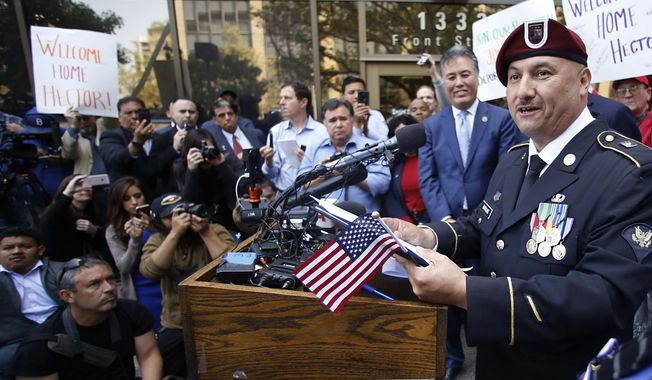 Hector Barajas speaks to the media at a news conference outside the United States Citizenship and Immigration Services office in downtown San Diego, Friday, April 13, 2018. Barajas, a decorated former U.S. Army paratrooper whose work on behalf of deported veterans drew widespread attention to his cause, became a U.S. citizen Friday, giving immigration advocates a rare reason to celebrate. (Alejandro Tamayo/The San Diego Union-Tribune via AP)