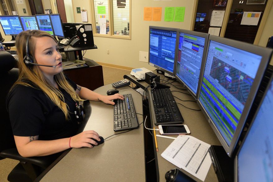 Lindsay Weidler, public safety tele communicator, answers a 911 call April 4, 2018, at the Erie County 911 Center in Summit Township, Pennsylvania. ( Jack Hanrahan/Erie Times-News via AP)