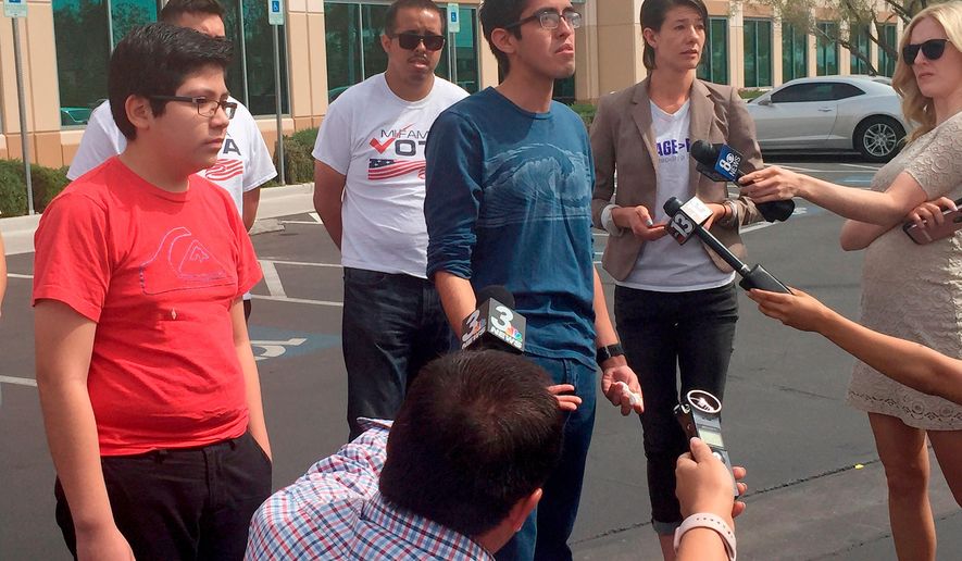 FILE - In this April 5, 2018, file photo, Eric Avelar-Gomez, front left, Ricardo Avelar-Gomez, center, and Bliss Requa-Trautz right, speak outside the Las Vegas office of U.S. Citizenship and Immigration Services Thursday, April 5, 2018, to call on immigration authorities to release from custody Mexican national Cecilia Gomez. Gomez was sent a notice to appear in court and, after she did not show for the court date, was then sent a notice of deportation, said Lori Haley, spokeswoman for U.S. Immigration and Customs Enforcement. But Gomez's family said she didn't find out about the correspondence until nearly 20 years later, when she was arrested on March 27 after she walked into the U.S. Citizen and Immigration Services office in Las Vegas to apply for permanent residency. (AP Photo/Regina Garcia Cano, File)