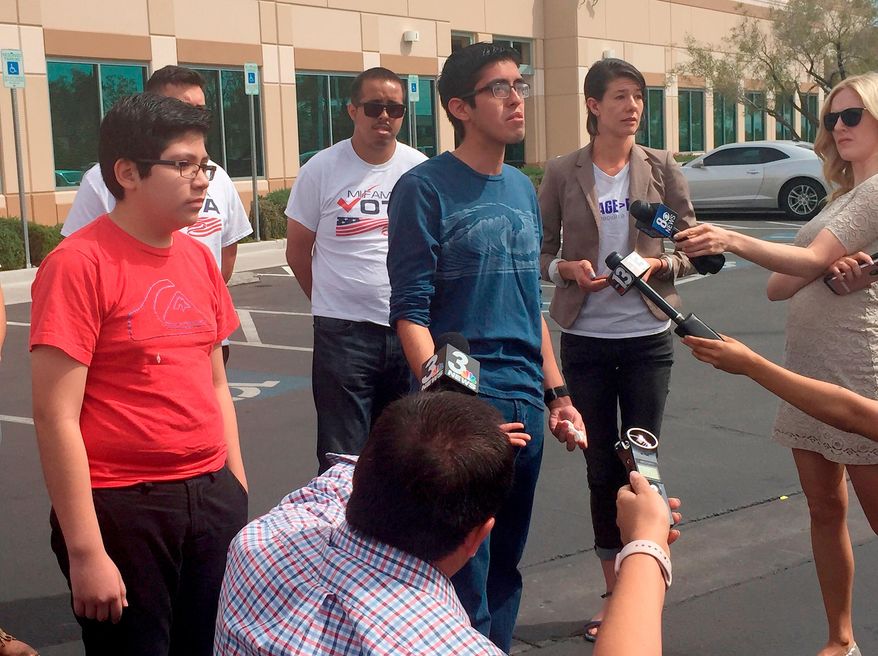 FILE - In this April 5, 2018, file photo, Eric Avelar-Gomez, front left, Ricardo Avelar-Gomez, center, and Bliss Requa-Trautz right, speak outside the Las Vegas office of U.S. Citizenship and Immigration Services Thursday, April 5, 2018, to call on immigration authorities to release from custody Mexican national Cecilia Gomez. Gomez was sent a notice to appear in court and, after she did not show for the court date, was then sent a notice of deportation, said Lori Haley, spokeswoman for U.S. Immigration and Customs Enforcement. But Gomez's family said she didn't find out about the correspondence until nearly 20 years later, when she was arrested on March 27 after she walked into the U.S. Citizen and Immigration Services office in Las Vegas to apply for permanent residency. (AP Photo/Regina Garcia Cano, File)