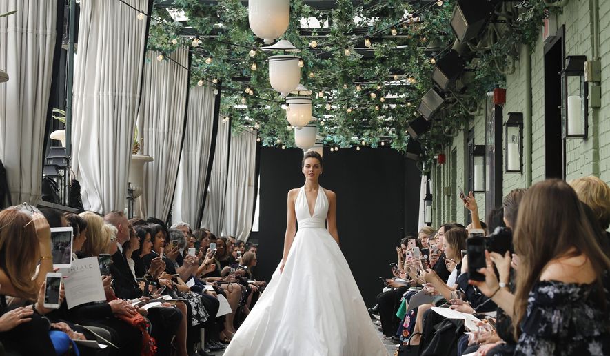 Bridal fashion from the Amsale collection is modeled during Bridal Fashion Week, Friday, April 13, 2018, in New York. (AP Photo/Bebeto Matthews)