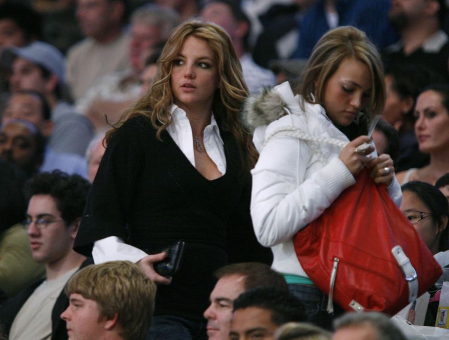 FILE- In this Dec. 17, 2006, file photo, Britney Spears, left, leaves with her sister Jamie Lynn Spears just before half time during the Washington Wizards and the Los Angeles Lakers NBA basketball game in Los Angeles. Britney Spears has a new niece. The singer on Thursday, April 12, 2018, tweeted congratulations to her sister, Jamie Lynn Spears, for the birth of her second daughter. (AP Photo/Mark Avery, File)