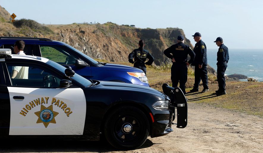 FILE - In this March 28, 2018, file photo, California Highway Patrol officers and deputy sheriffs from Mendocino and Alameda counties gather after a search for three missing children at the site where the bodies of Jennifer and Sarah Hart and three of their adopted children were recovered two days earlier, after the family's SUV plunged over a cliff at a pullout on the Pacific Coast Highway near Westport, Calif. Three of the children, Devonte Hart, 15, Hannah Hart, 16, and Sierra Hart, 12, have not been found. Authorities say a woman who drove off California cliff last month in an SUV carrying her wife and children was drunk. California Patrol Capt. Bruce Carpenter said Friday, April 13, 2018, that toxicology tests found Jennifer Hart had an alcohol level of .102. California drivers are considered drunk with a level of 0.08 or higher. Authorities don't know who was at the wheel at the time of the accident. (Alvin Jornada/The Press Democrat via AP, File)