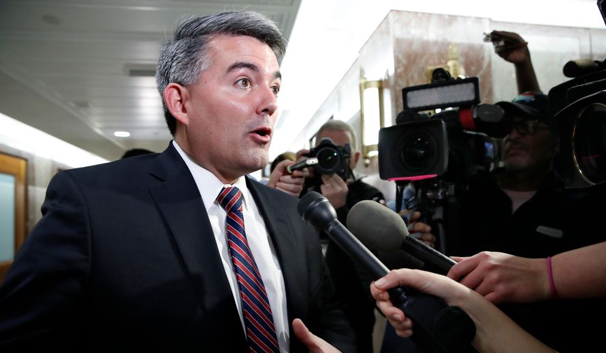 In this Jan. 22, 2018, file photo, Sen. Cory Gardner, R-Colo., left, speaks to the media after attending a meeting with a bipartisan group of senators on day three of the government shutdown on Capitol Hill in Washington. (AP Photo/Jacquelyn Martin, File)