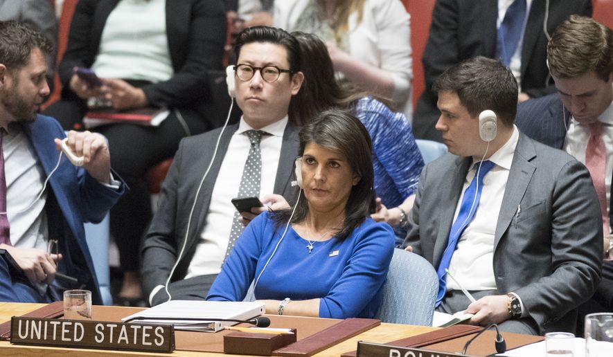 American Ambassador to the United Nations Nikki Haley listens as Syrian Ambassador to the United Nations Bashar Ja&#39;afari speaks after a vote on a resolution during a Security Council meeting on the situation in Syria, Saturday, April 14, 2018 at United Nations headquarters. (AP Photo/Mary Altaffer)