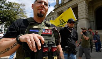 Shaun Baby, of Cartersville, Ga., participates in a gun-rights rally at the state capitol, Saturday, April 14, 2018, in Atlanta.  About 40 gun rights supporters have gathered for one of dozens of rallies planned at statehouses across the U.S.  (AP Photo/Mike Stewart)
