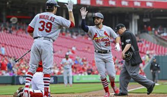 St. Louis Cardinals&#39; Greg Garcia high fives Miles Mikolasin after hitting a home run in the second inning of a baseball game against the Cincinnati Reds, Saturday, April 14, 2018, in Cincinnati. (AP Photo/Aaron Doster)