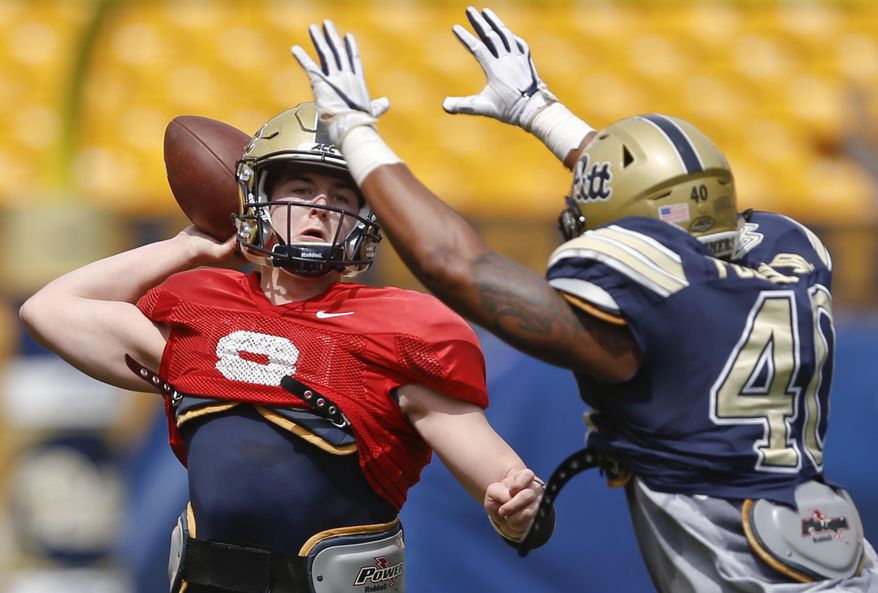 Pittsburgh quarterback Kenny Pickett (8) passes under pressure by defensive lineman James Folston Jr. (40) during their annual NCAA intrasquad college football spring Blue Gold game, Saturday, April 14, 2018, in Pittsburgh. The Blue team won 10-3. (AP Photo/Keith Srakocic)