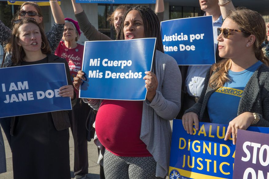 Activists with Planned Parenthood demonstrate in support of a pregnant 17-year-old being held in a Texas facility for unaccompanied immigrant children to obtain an abortion, outside of the Department of Health and Human Services in Washington. (AP Photo/J. Scott Applewhite File)