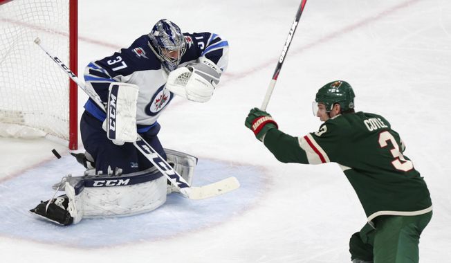 Minnesota Wild center Charlie Coyle (3) celebrates as a goal by Wild teammate Jordan Greenway slips past Winnipeg Jets goalie Connor Hellebuyck (37) in the second period of Game 3 of an NHL first-round hockey playoff series Sunday, April 15, 2018, in St. Paul, Minn. (AP Photo/Andy Clayton-King)
