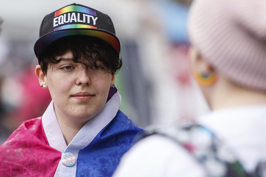 Spencer Powell, of Bloomfield, Ind., takes part in the first-ever Columbus Pride Festival in downtown Columbus, Ind., Saturday, April 14, 2018. The festival was organized by Erin Bailey, a senior at Columbus Signature Academy New Tech High School, for her senior project. The Indiana high school student organized what's believed to be the first gay pride festival in Vice President Mike Pence's hometown. (Mike Wolanin /The Republic via AP)
