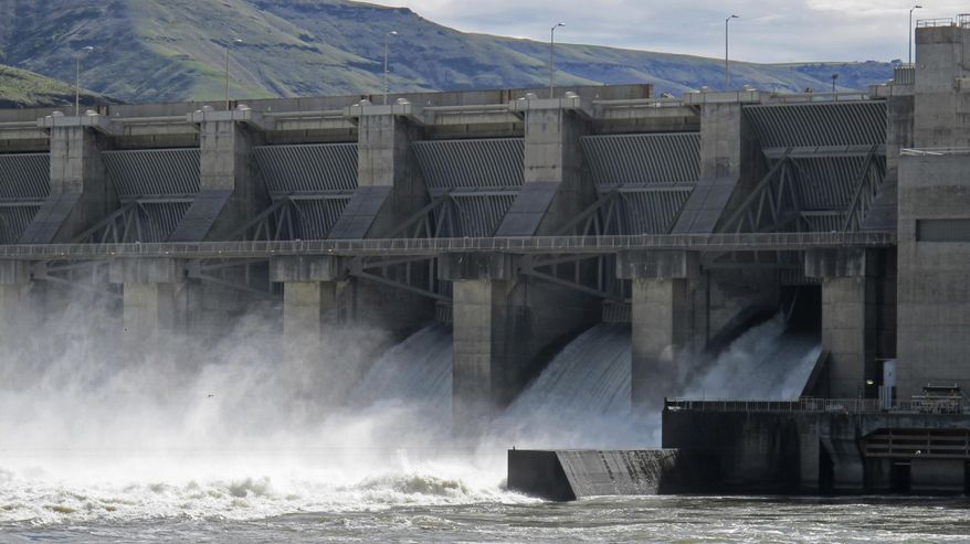 In this April 11, 2018 photo, water moves through a spillway of the Lower Granite Dam on the Snake River near Almota, Wash. Republican members of Congress from the Pacific Northwest are upset with a federal judge's order to spill water from the dam and three others on the Snake River in an attempt to help speed migrating salmon to the Pacific Ocean, saying the increased spill will result in lost power sales and could harm transportation, barging, flood control and irrigation systems. (AP Photo/Nicholas K. Geranios)